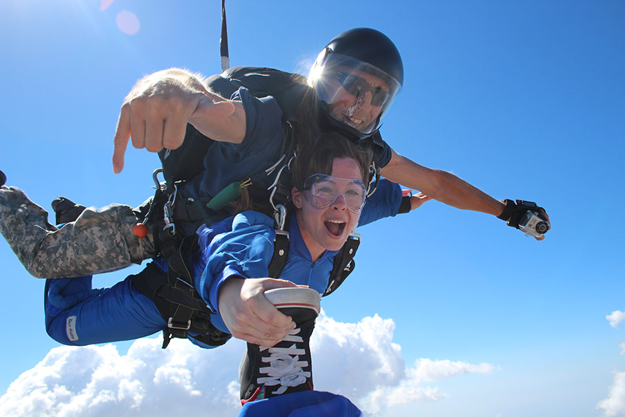 girl grabs shoe of Los Angeles tandem skydiving photographer