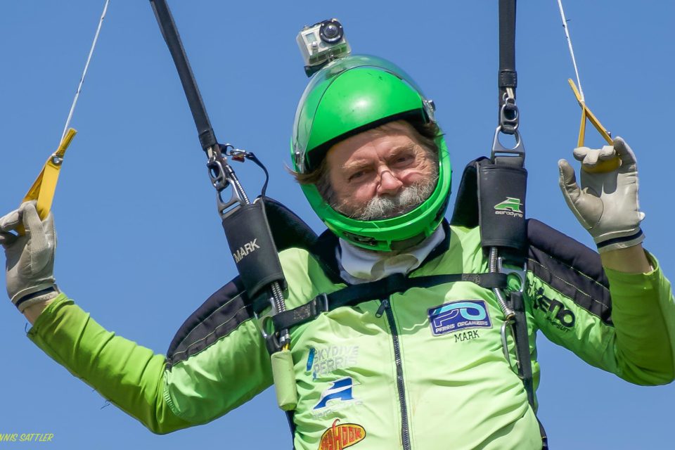 Mark Brown prepares for landing in his signature neon green jumpsuit.