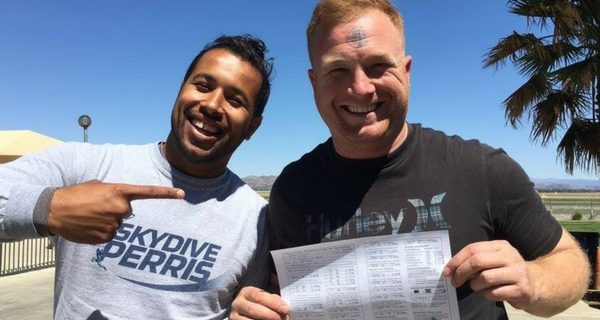 man holds up skydiving license at Perris