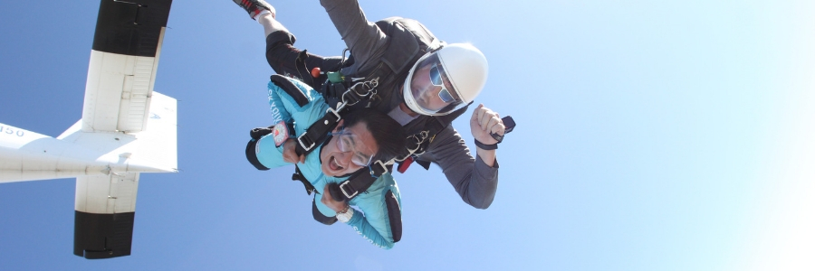 first time skydiving student opens mouth with excitement in skydiving freefall