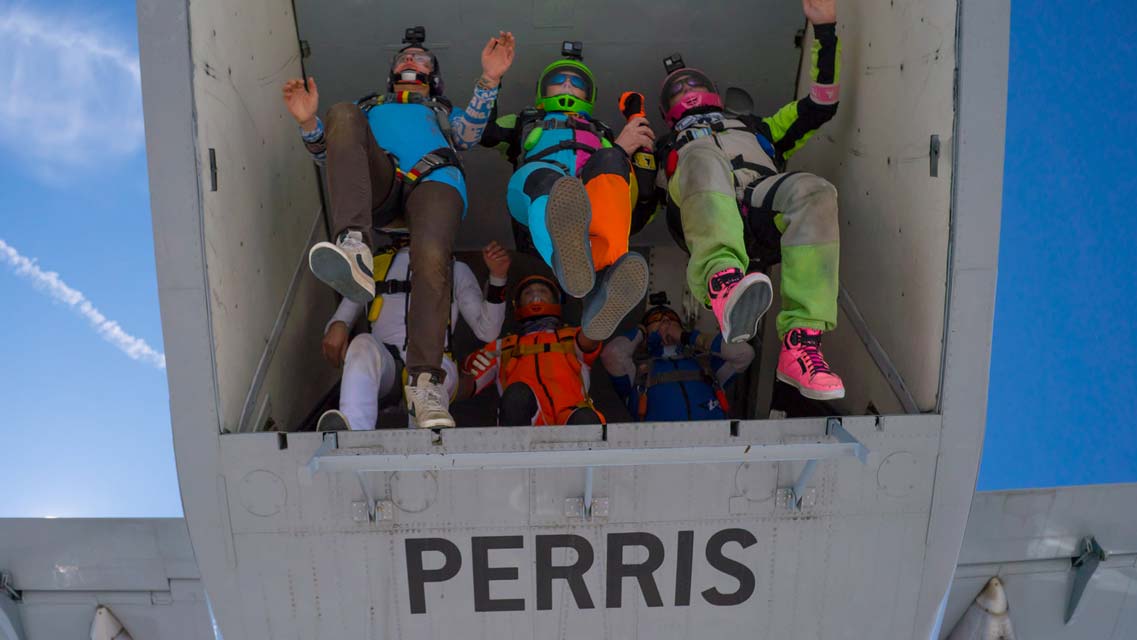 A group of jumpers stand on the tailgate of the SkyVan before exiting from 12,500'