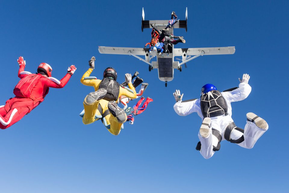 Exit shot of several jumpers leaving a Shorts Skyvan at 12,500'