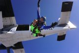 a tandem student exits a twin otter at 12,500' at Skydive Perris